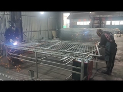 Fence mesh is being welded by workers